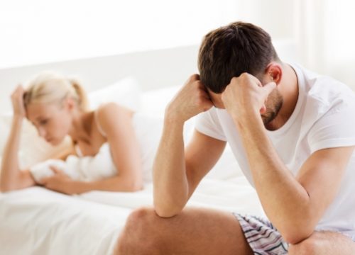 Photo of a frustrated couple in bed
