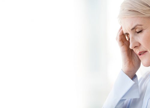 Photo of an older woman with a headache